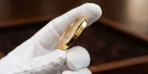 Gold coin being held